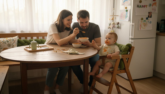 Parents feeding infant first solid foods