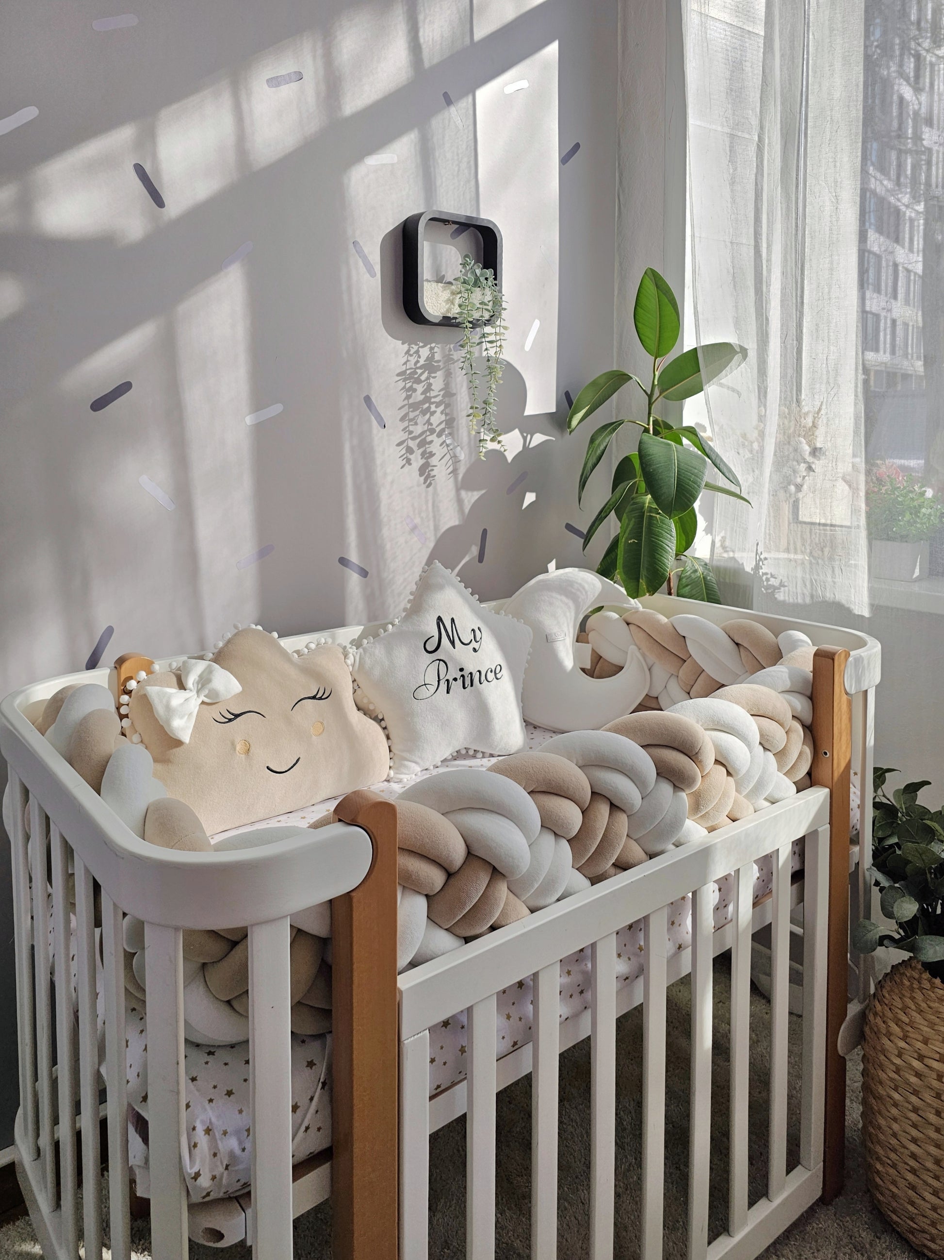 Beige baby crib bedding set with braided crib bumper. Kari studio