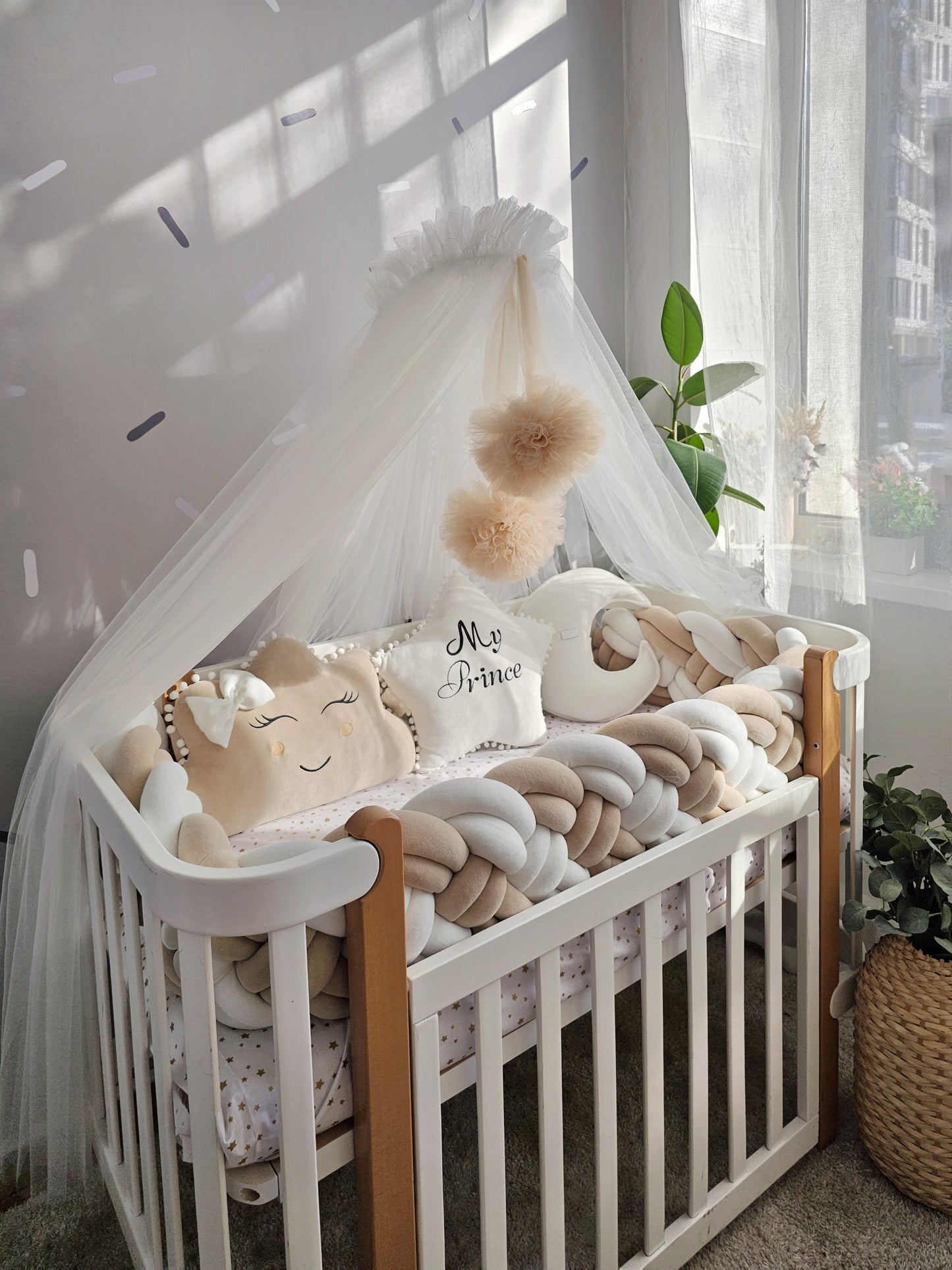 Beige baby crib bedding set with braided crib bumper. Kari studio