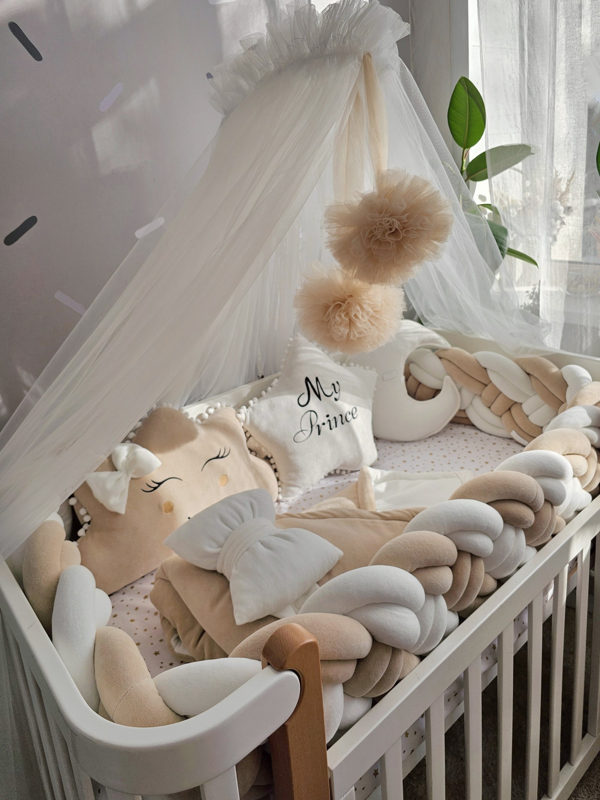 Beige baby crib bedding set with braided crib bumper. Kari studio