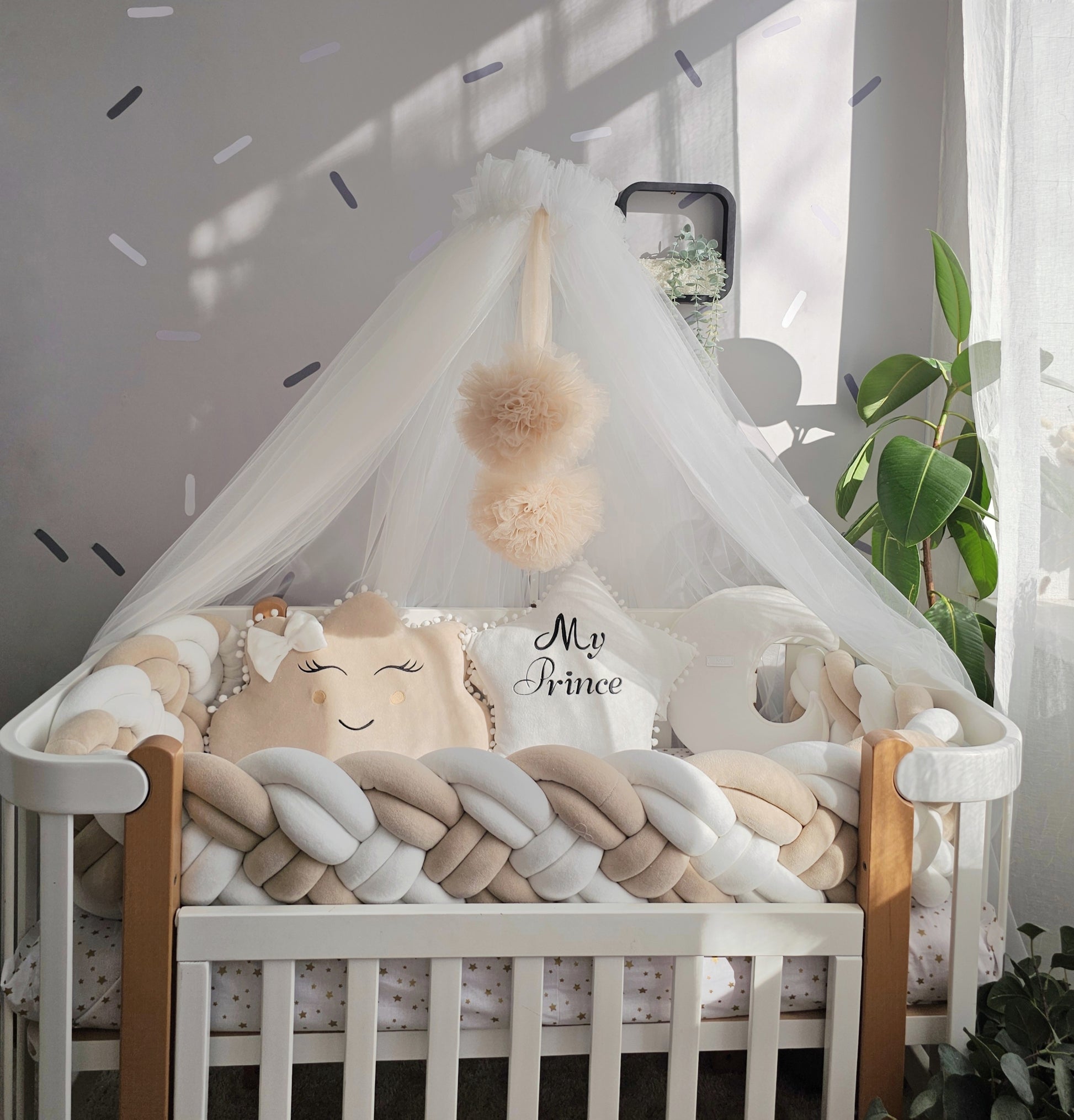 Beige baby crib bedding set with braided crib bumper. Kari studio