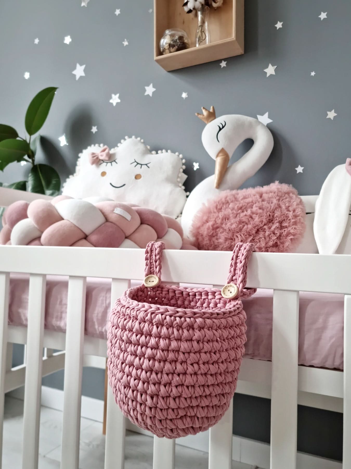 Children's room with a crib, plush toys, and decorative elements.