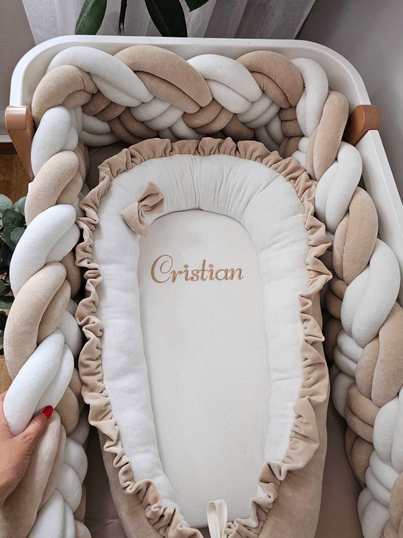 Beige baby crib bedding with braided crib bumper. KARI studio