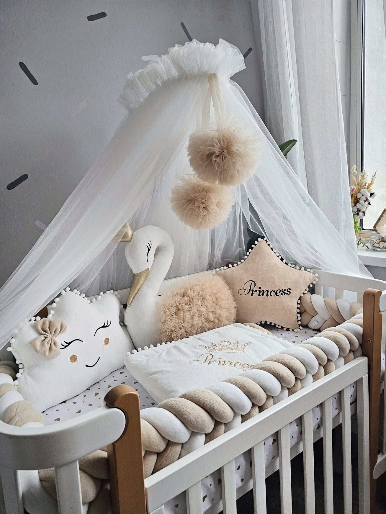 Beige baby crib bedding with braided crib bumper. KARI studio