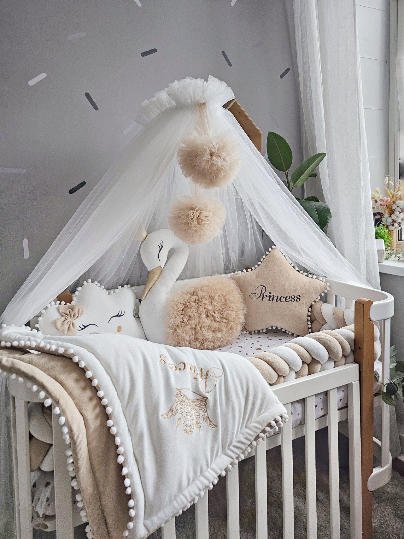 Beige baby crib bedding with braided crib bumper. KARI studio