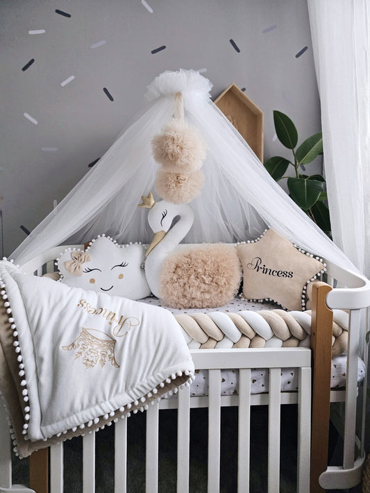 Beige baby crib bedding with braided crib bumper. KARI studio