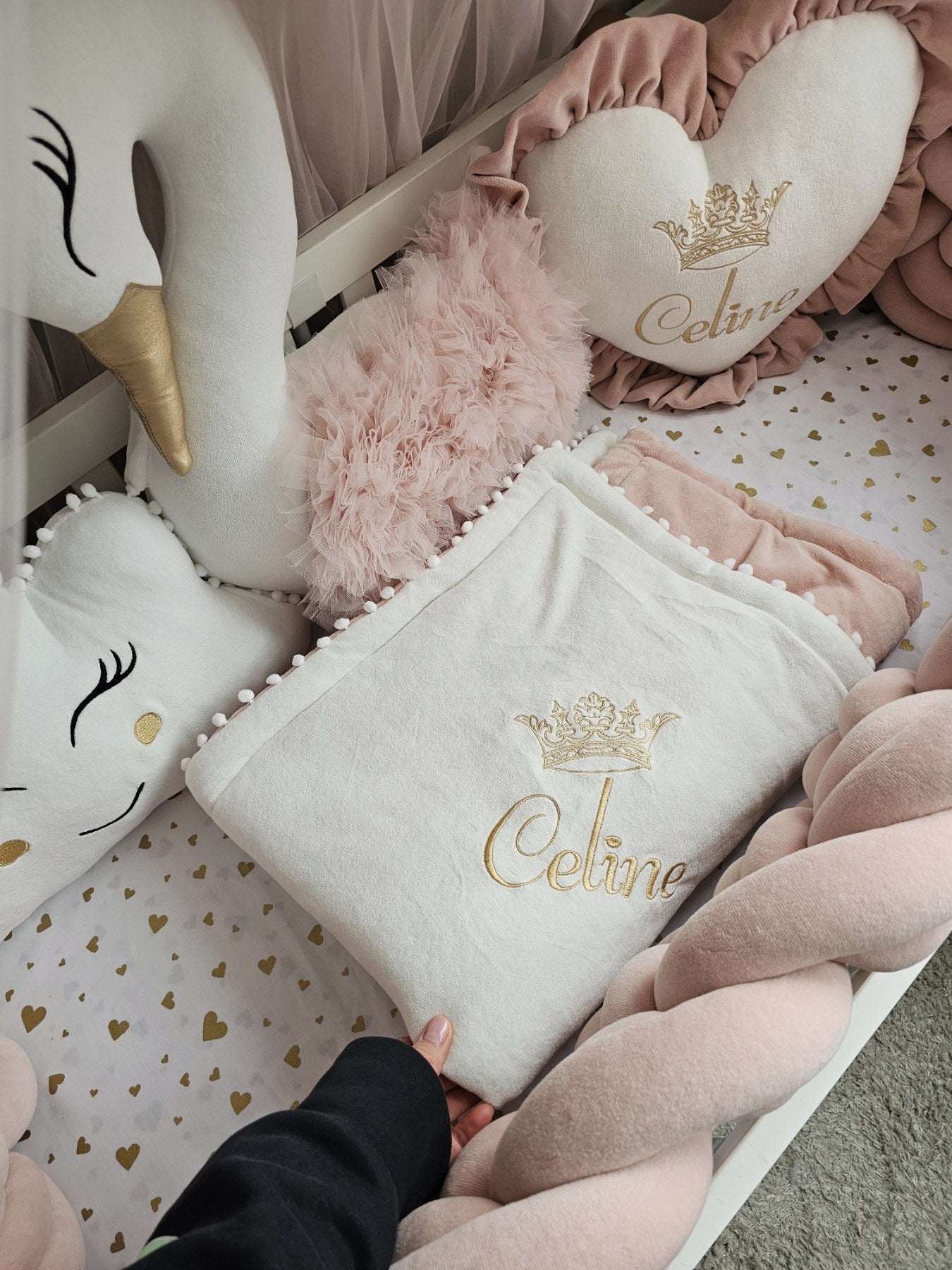 Decorative pillows with 'Celine' branding on a patterned surface